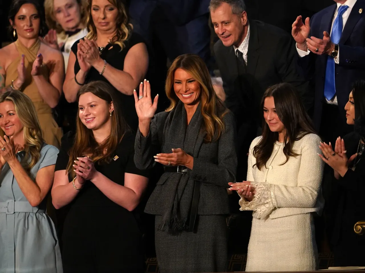 From cheers to protests, here's a look inside the chamber during Trump's speech 2 First Lady Melania Trump (center) waves as she attends US President Donald Trump's address to a joint session of Congress in the House Chamber of the Capitol.