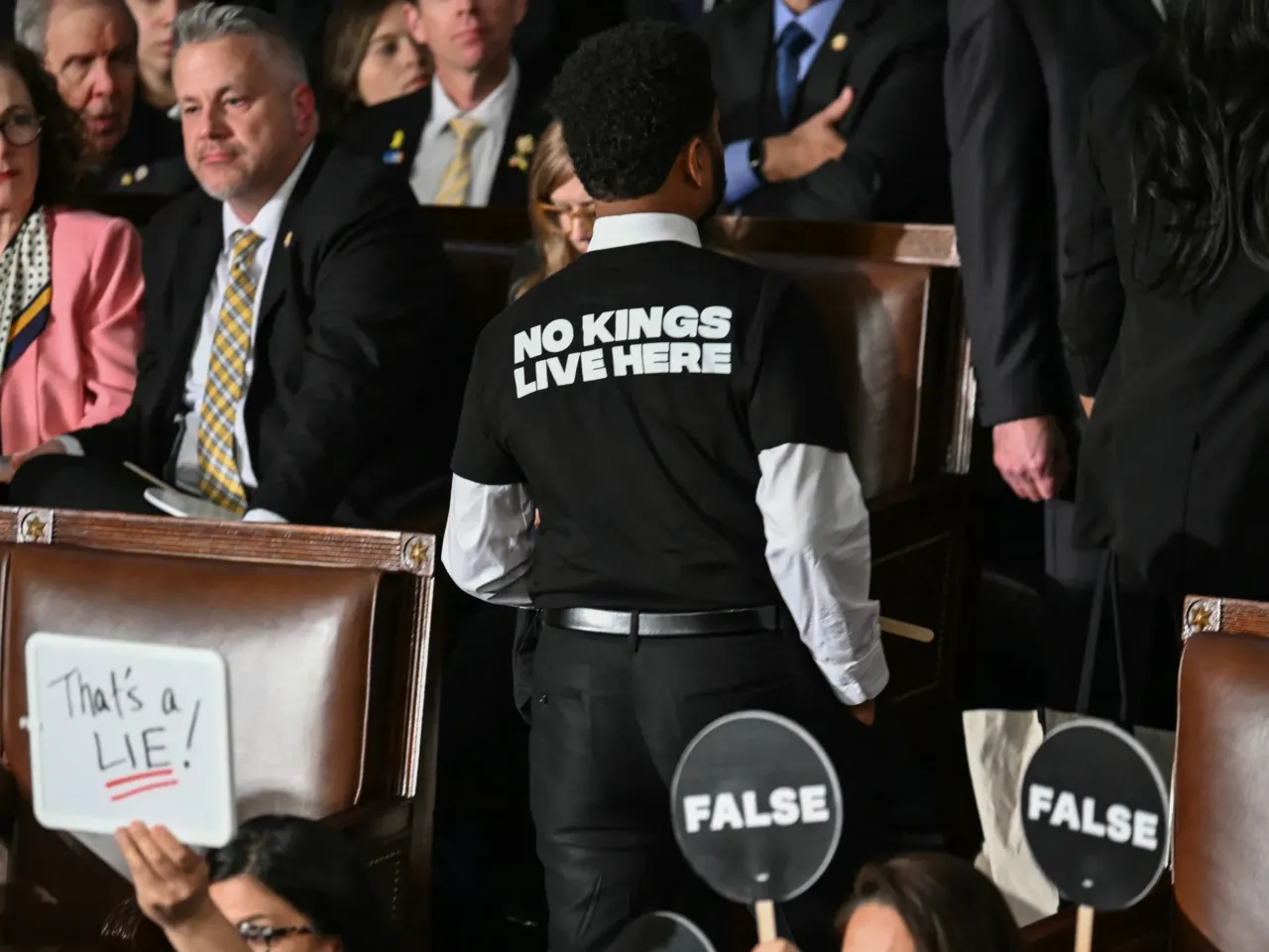 From cheers to protests, here's a look inside the chamber during Trump's speech 6 Representative Maxwell Frost, Democrat from Florida, wears a shirt reading "No kings live here" as he walks out of the House Chamber while US President Donald Trump speaks during an address to a joint session of Congress.