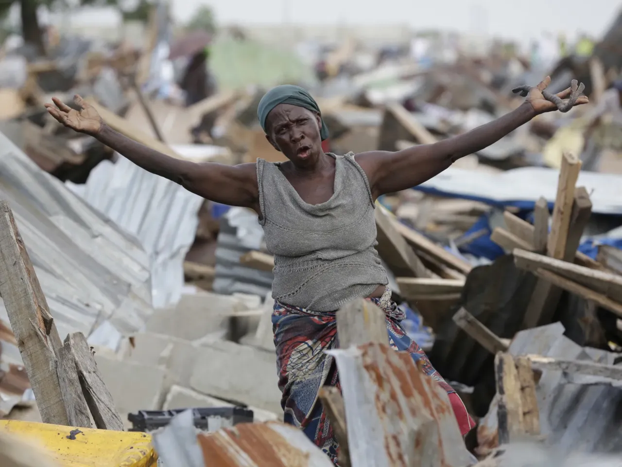 A woman gestures in front of her demolished house in Otodo-Gbame waterfront in Lagos, Nigeria. Saturday, March 18, 2017. Slums and shantytowns are often targeted in rampant demolitions across Africa's most populous country