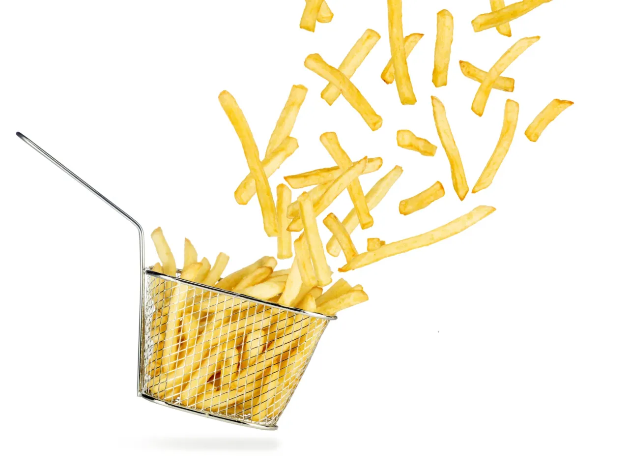 French fries flying out of falling stainless steel fryer basket isolated on white background.