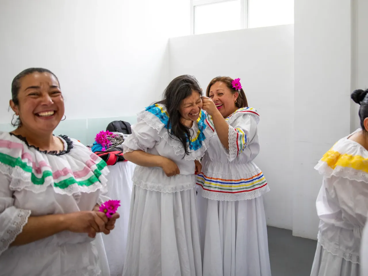 Ruth Infante (second from left), a single mother of three, and her classmates donned traditional flowing dresses for their Cumbia dance performance at a center in Bogotá, Colombia, that provides happy respite for family caregivers.