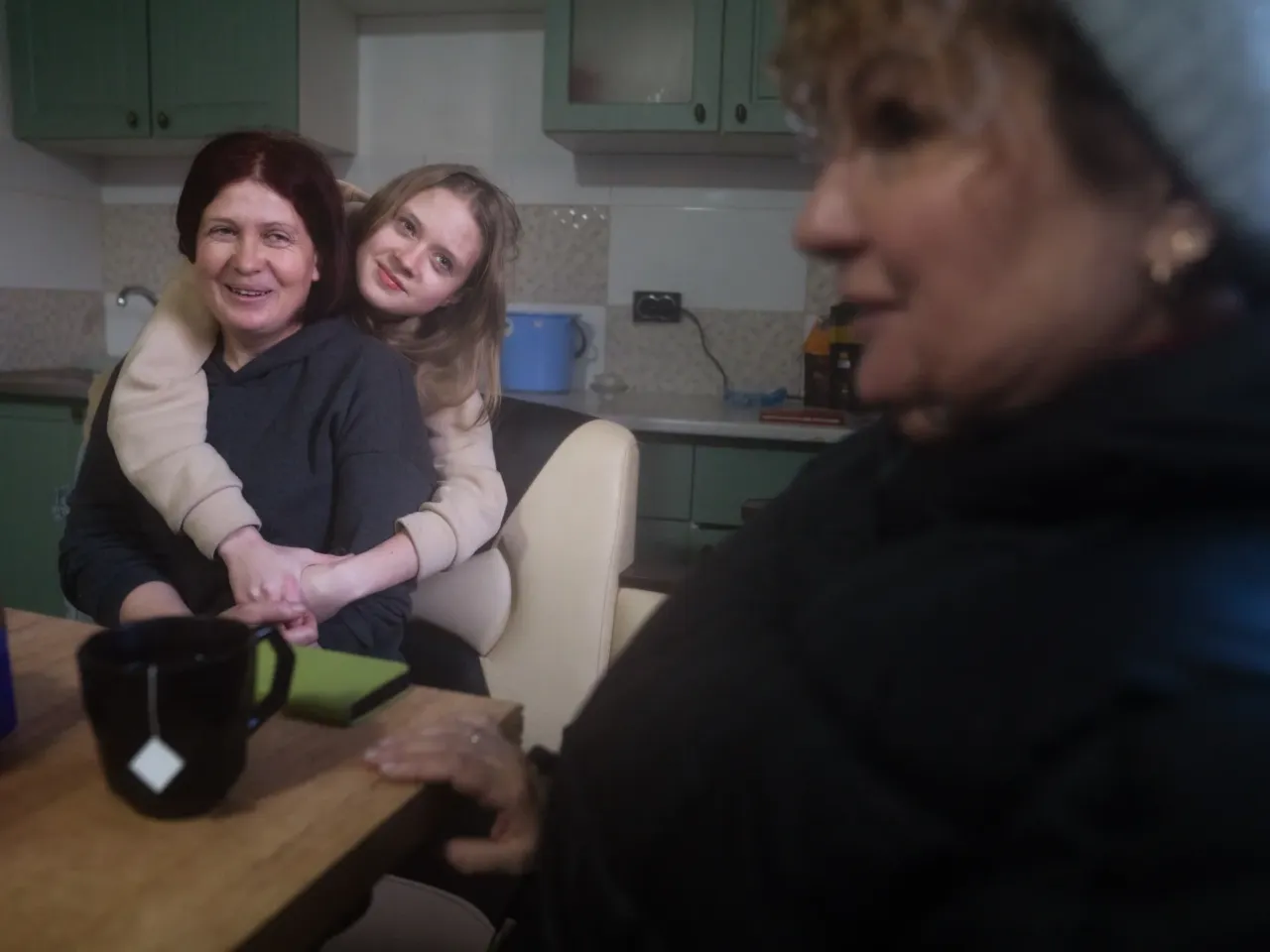 Ukrainians in front-line regions reel from losses, but say hope dies last for them 6 Nadia Huscha, 37, (left) and her daughter Anna, 14, talk with Oksana Hnedko in their home that was repaired in Zelenyi Hai. With most of the town's buildings already fixed, Hnedko and Huscha can actually dream of a return to normal. They reminisce about the annual village celebration, the last of which they had in 2021. And they talk about their hopes of having another celebration again someday.
