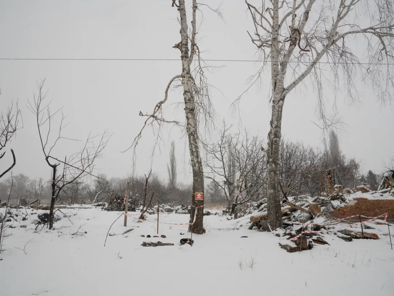Ukrainians in front-line regions reel from losses, but say hope dies last for them 16 Destroyed homes in Staryi Saltiv are blanketed with snow in February. A sign warns of landmines and tape marks pieces of possibly unexploded ordnance on the ground.