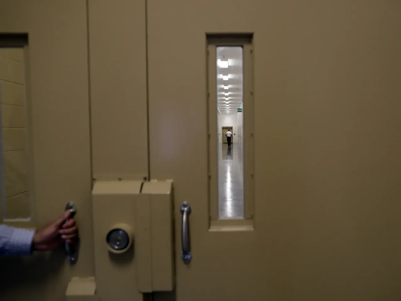 A man walks in a hallway at the Otay Mesa Detention Center Wednesday, Aug. 23, 2017, in San Diego.