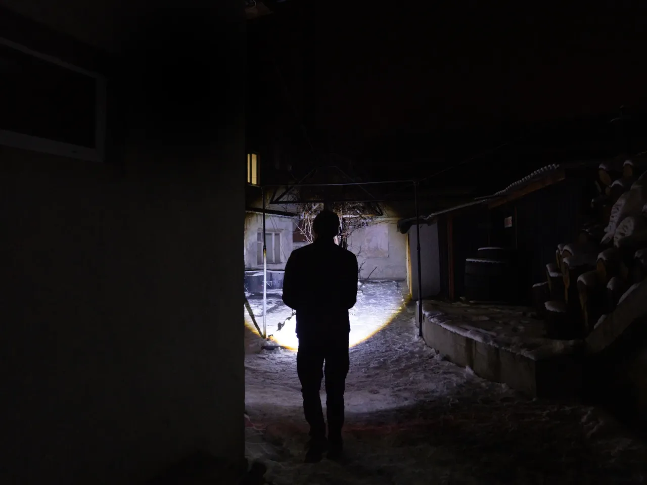 Ukrainians face fears during the country's darkest nights 6 Lohinov uses a flashlight just to walk from one building to another at night in the fire station.