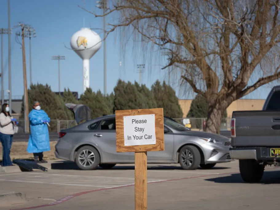 Signs point the way to measles testing in the parking lot of the Seminole Hospital District across from Wigwam Stadium on February 27, 2025 in Seminole, Texas.