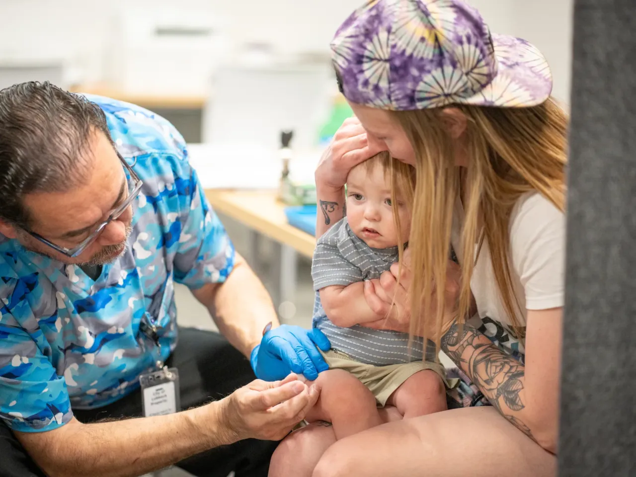 One-year-old River Jacobs is held by his mother, Caitlin Fuller, while he receives an MMR vaccine from Raynard Covarrubio, at a vaccine clinic held by the Lubbock Public Health Department on March 1 in Lubbock, Texas. A measles outbreak in West Texas has led to more than 500 cases, 57 hospitalizations and the deaths of two school-age children.