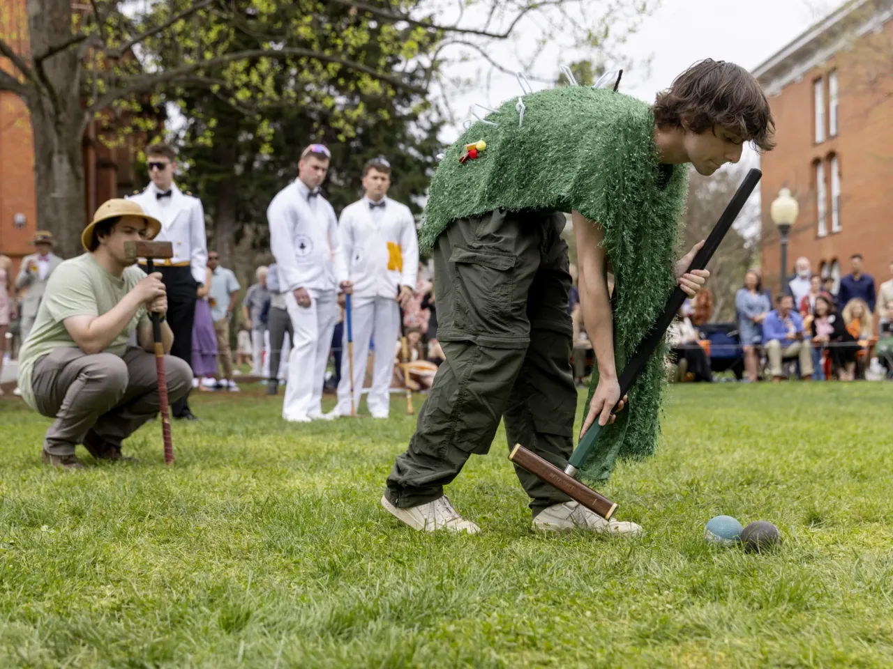 'The lawn giveth and the lawn taketh away': Photos from the 41st Annapolis Cup 6 St. John's Dalton Olsson swings as teammate Angus Preston and members of the Naval Academy's team look on.