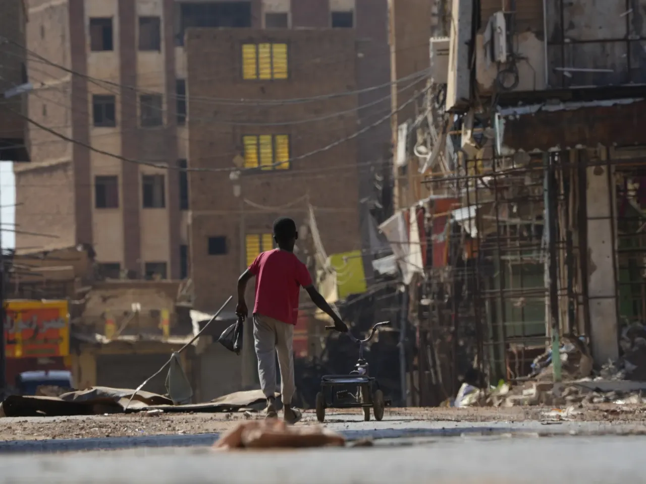 Photos: 2 years of war in Sudan 13 A child pushes a tricycle as he returns home in Sudan's Omdurman Market in 2024.