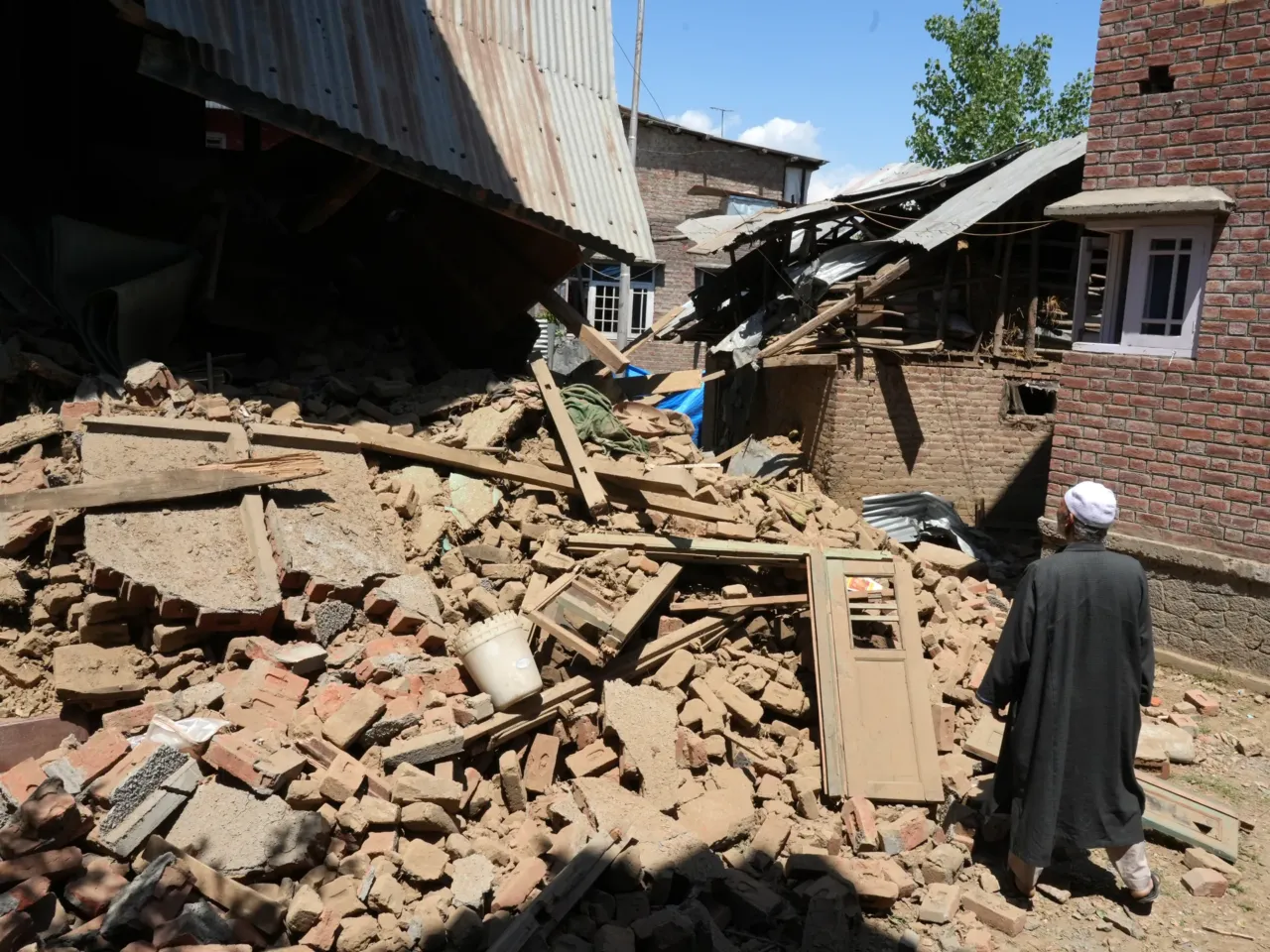 Homes destroyed and 1,500 detained in Kashmir as India cracks down following attacks 1 An elderly man inspecting the demolished family house of alleged Kashmiri militant Adil Thoker in Guree village of South Kashmir.