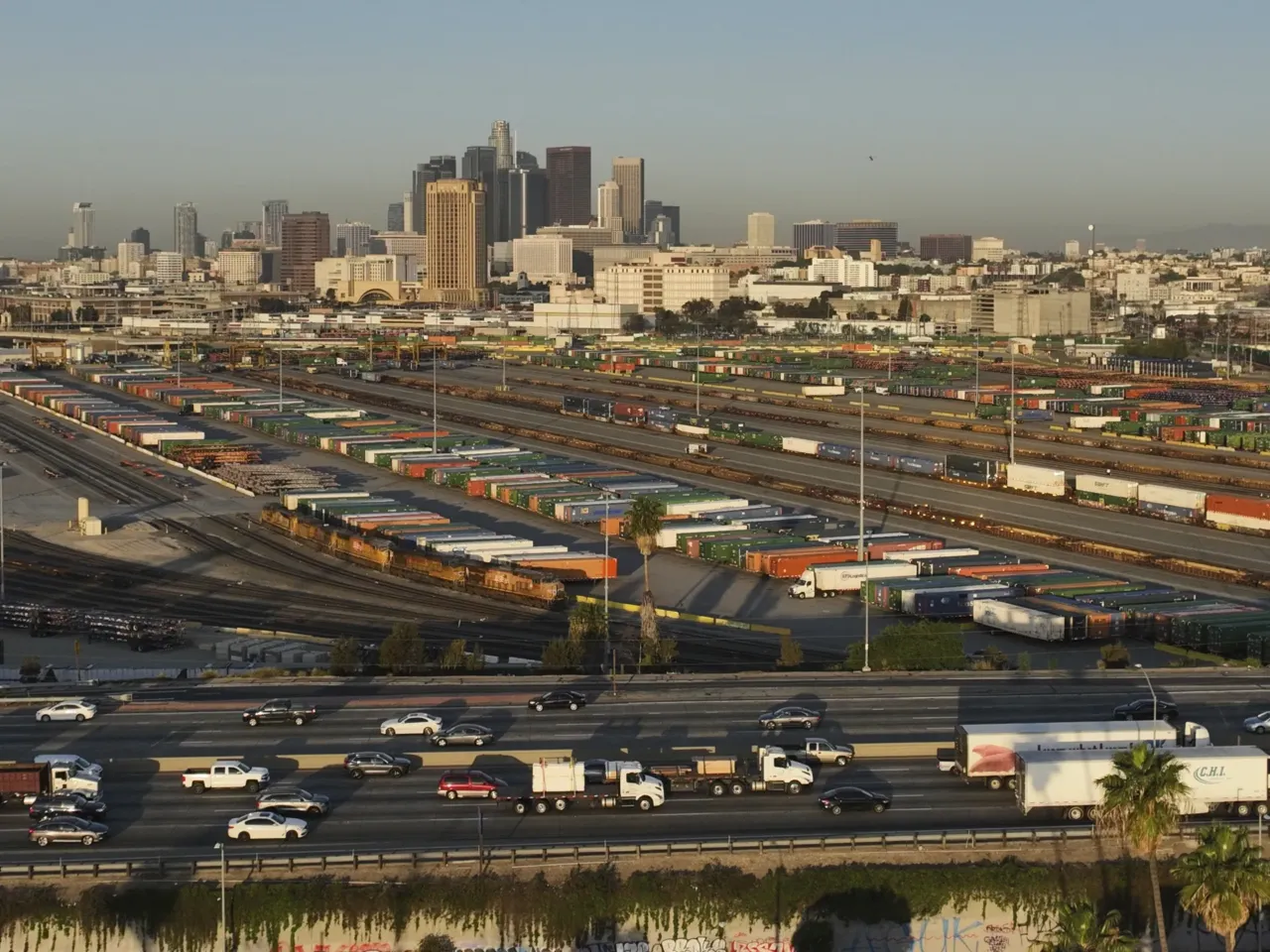 Traffic flows on Interstate 5 past shipping containers near downtown Los Angeles, Tuesday, April 8, 2025.