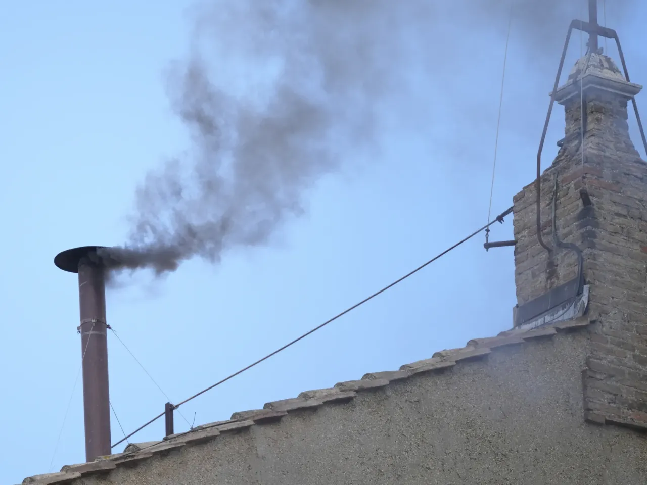 Black smoke billows from the chimney of the Sistine Chapel during the conclave to elect a new pope, at the Vatican, Thursday, May 8, 2025.