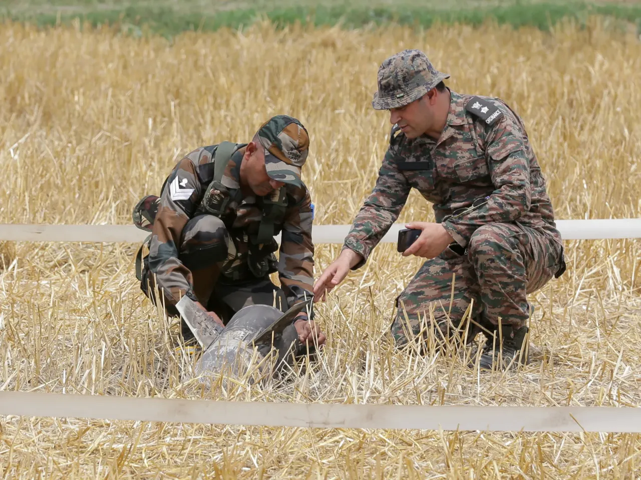India and Pakistan trade attacks amid risk of war between nuclear states 3 Army personnel examine the remains of a projectile discovered in Makhanwindi village near Amritsar, India, on Thursday.