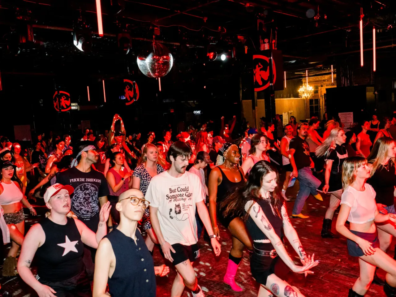 New to your queerness? Here's how to find a supportive community in your area 1 A crowd line dances at Stud Country in Brooklyn, N.Y., on March 25, 2025.