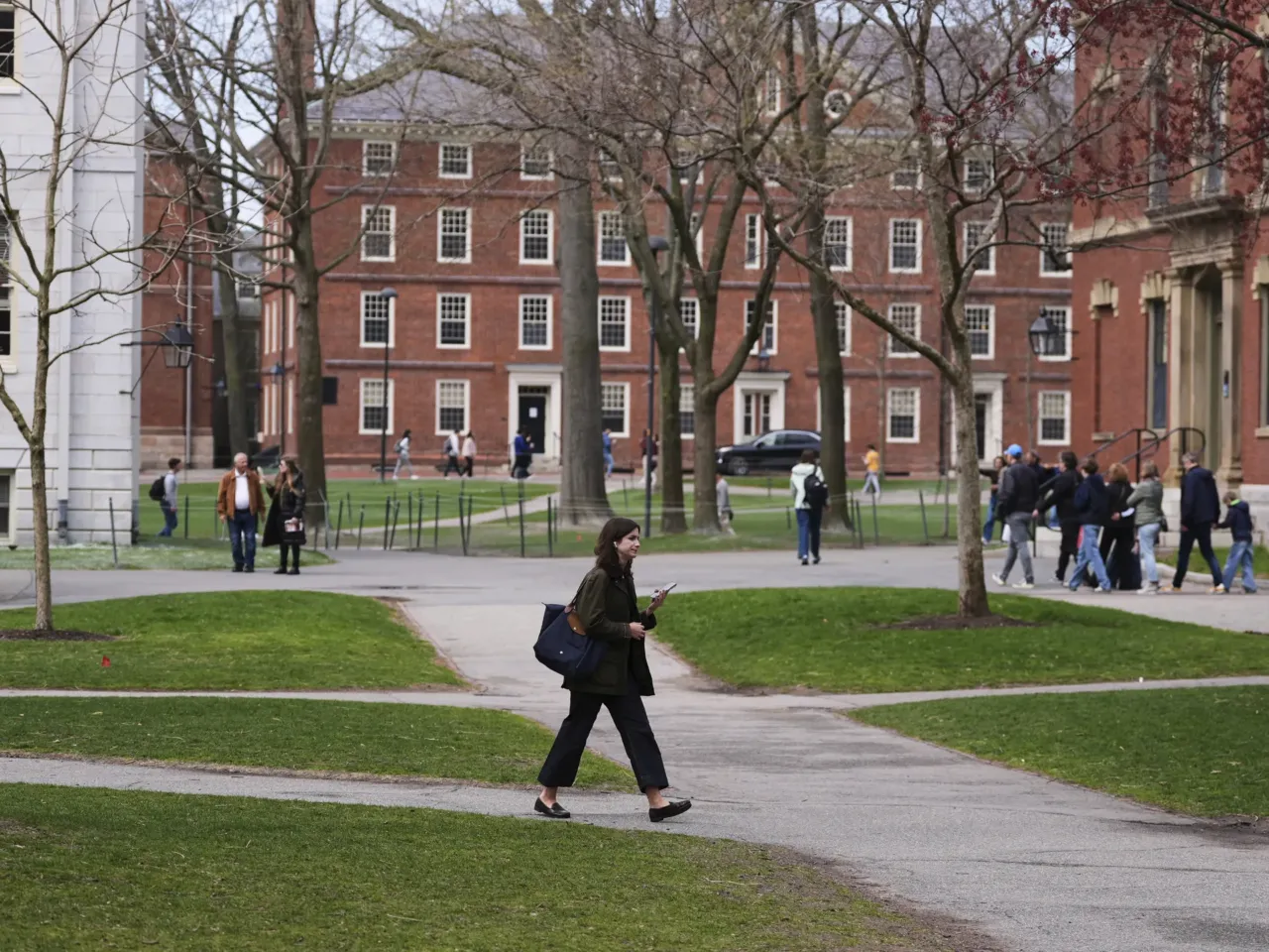 As Trump targets elite schools, Harvard's president says they should 'stand firm' 1 Pedestrians walk through Harvard Yard at Harvard University, Tuesday, April 15, in Cambridge, Mass.