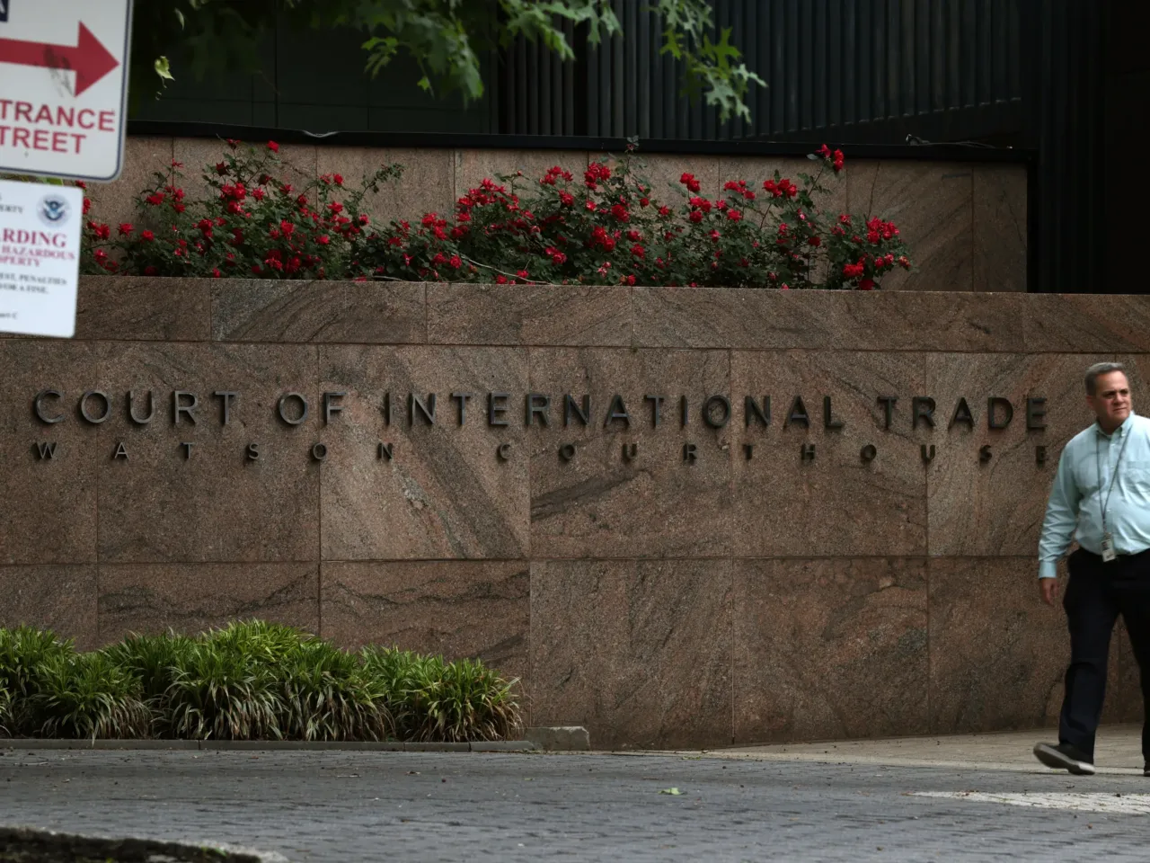 People walk past the U.S. Court of International Trade, Watson Courthouse, in lower Manhattan on Thursday. In a ruling that surprised many, the Manhattan-based trade court ruled in an opinion by a three-judge panel that a 1977 law called the International Emergency Economic Powers Act does not grant Trump "unbounded" authority to impose the worldwide and retaliatory tariffs he has issued by executive order.