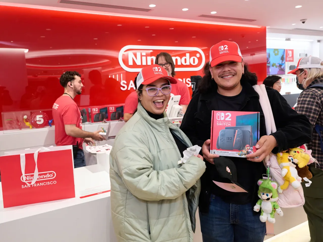 Fans drive huge Nintendo Switch 2 launch; others play the waiting game 2 Fans pose with Nintendo Switch 2 systems at a new Nintendo store in San Francisco.
