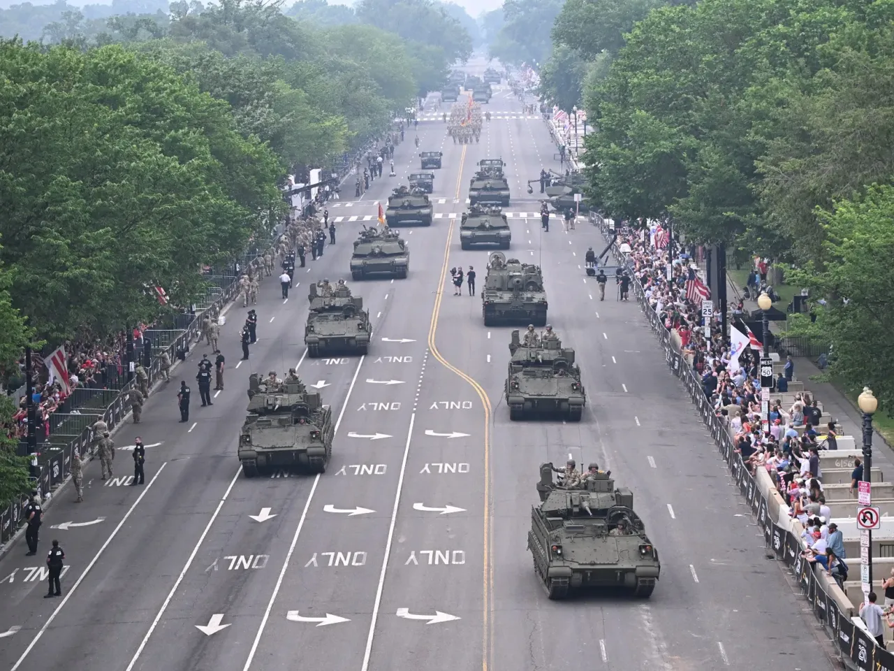 3 takeaways from the military parade and No Kings protests on Trump's birthday 1 Armored vehicles drive during the Army's 250th anniversary parade in Washington, D.C., on Saturday.