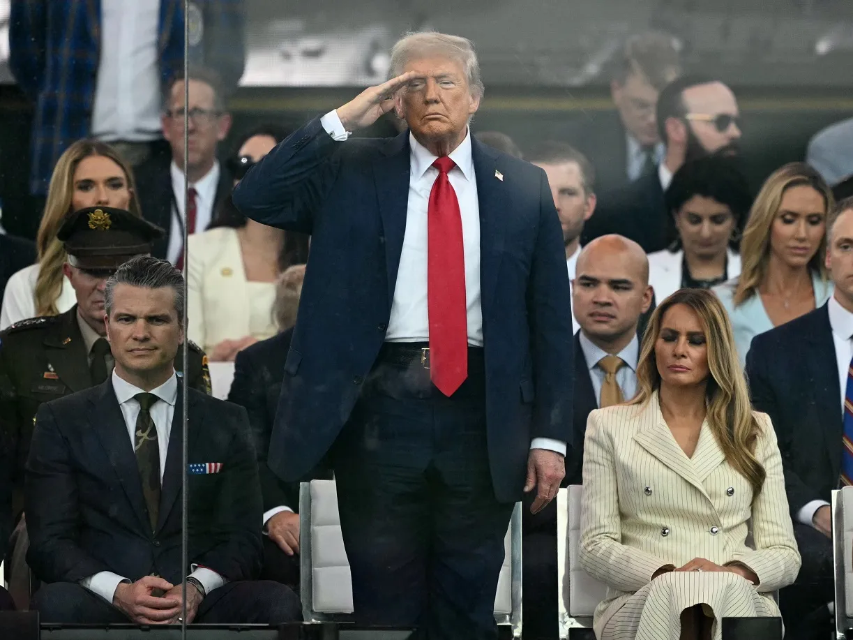 3 takeaways from the military parade and No Kings protests on Trump's birthday 3 President Trump stands and salutes, flanked by Secretary of Defense Pete Hegseth and first lady Melania Trump.
