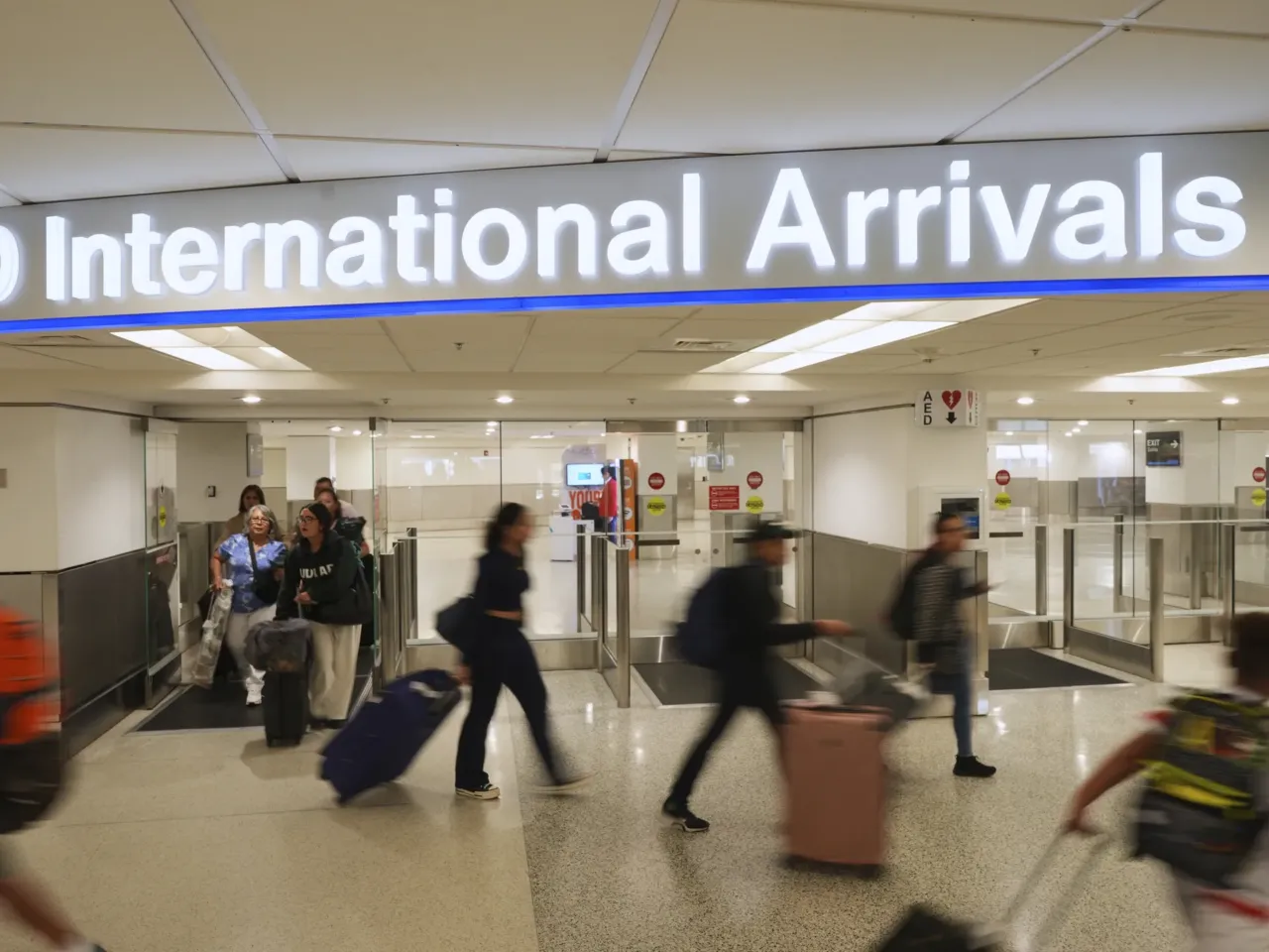 Passengers arrive on international flights at Miami International Airport, Monday, June 9, in Miami.