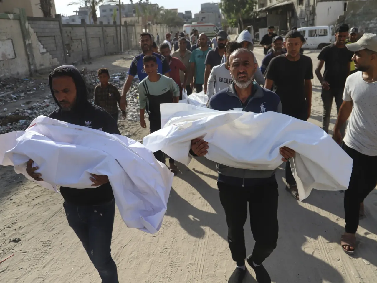 As Israel turns its focus to Iran, the death toll mounts in Gaza — and hunger deepens 1 Palestinians carry the bodies of relatives killed in an Israeli strike, at Nasser Hospital in Khan Younis on Tuesday.