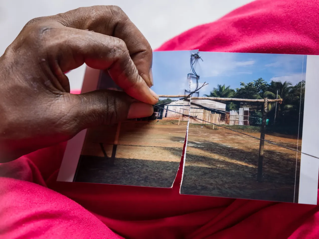 Photos: How torn pictures and trusted herbs create healing in Colombia 6 Carmen Fidela Mena, a healer and midwife, sews up a photo as a symbolic way of healing the community's suffering.