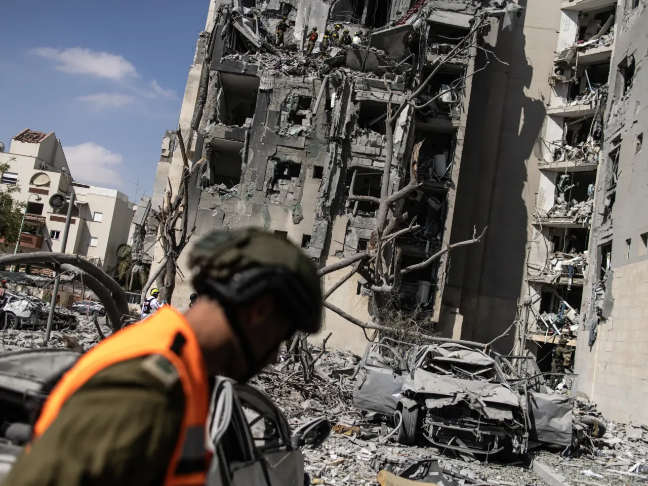After lashing out at Israel and Iran, Trump says the 'ceasefire is in effect' 1 Israeli emergency services and security officers search for casualties in the rubble of a building hit by an Iranian missile in Beersheba in southern Israel on Tuesday.
