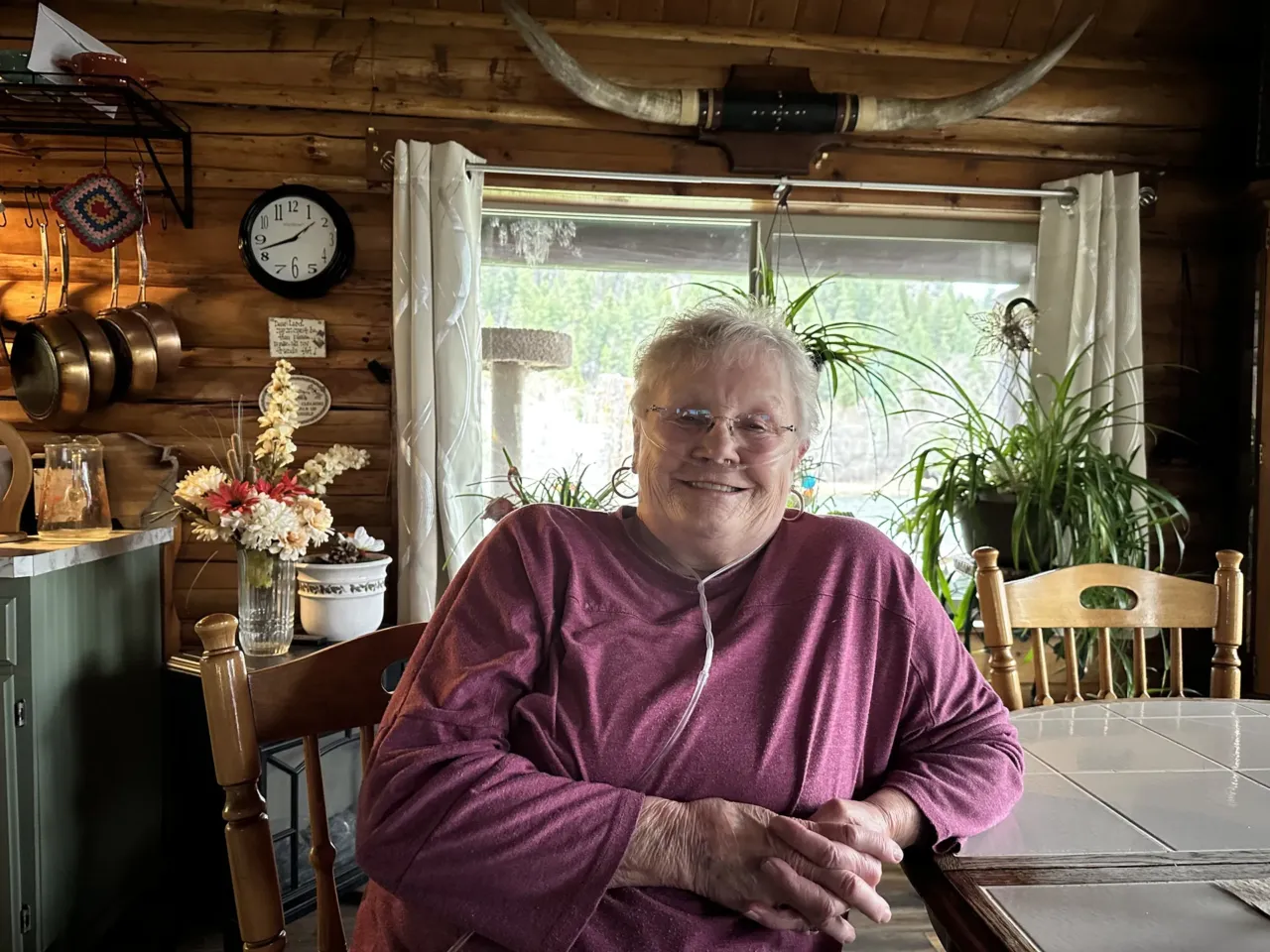 Gayla Benefield sits at her kitchen table in her home just outside of Libby, MT. Benefield struggles to breathe because her lungs were scarred by asbestos. Benefield helped start the Center for Asbestos Related Disease, or CARD Clinic, to help people get diagnosed. She said previous generations like her parents died without knowing what was killing them.