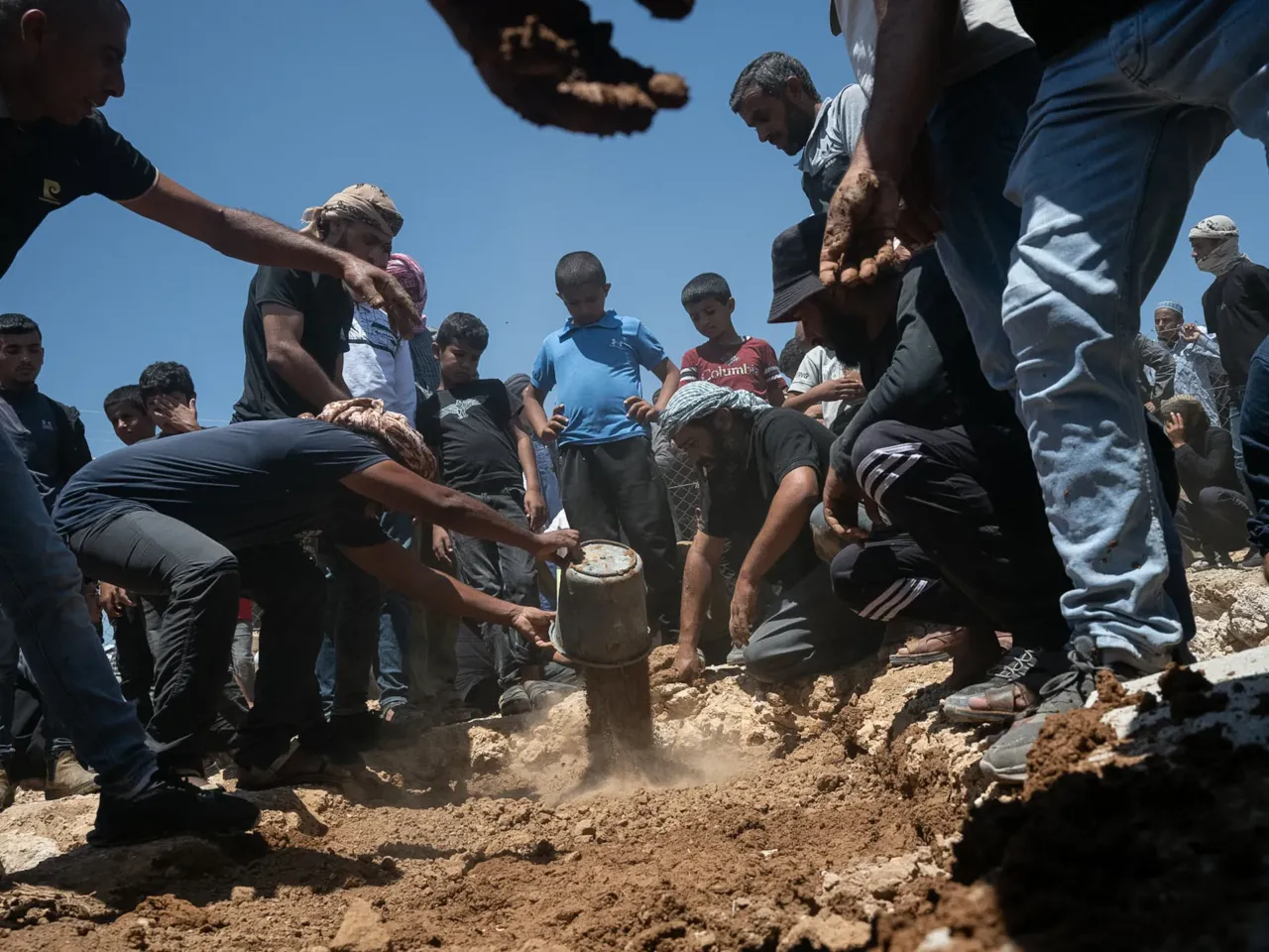 A Palestinian activist was killed by the violence he sought to stop 2 Family and friends of Palestinian activist Awdah Hathaleen bury his body during his funeral.