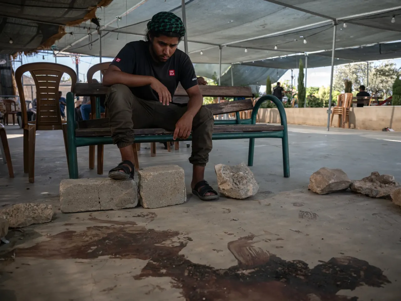 A Palestinian activist was killed by the violence he sought to stop 3 Suliman Hathaleen, a relative of Palestinian activist Awdah Al Hathaleen, sits at the site where Hathaleen was shot in the Umm al-Khair community center as people gather to mourn his death on Aug. 3.