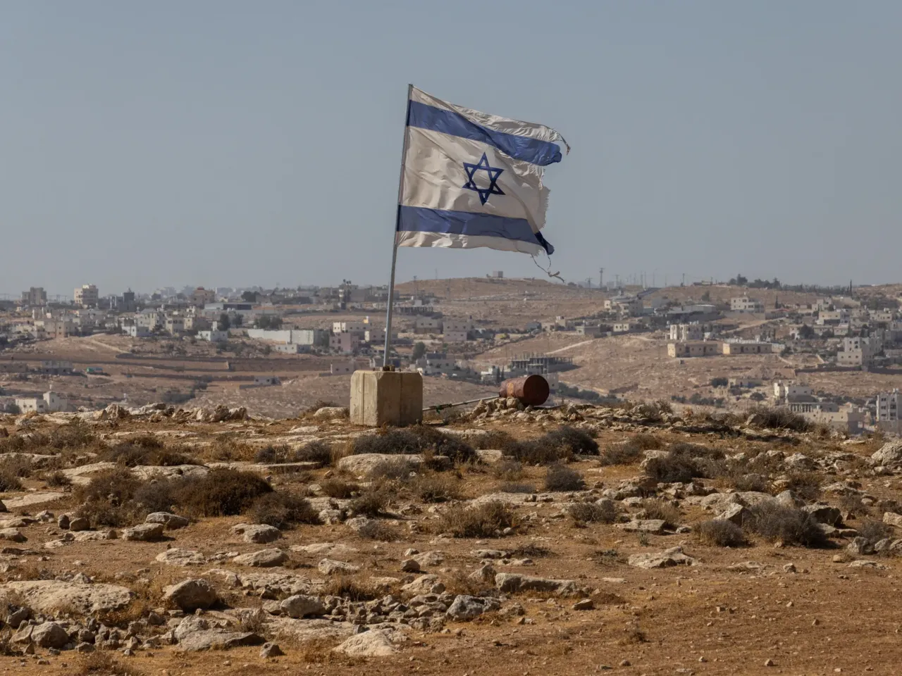 A Palestinian activist was killed by the violence he sought to stop 5 An Israeli flag flies along a highway near the settlement of Carmel on Aug. 4, in the South Hebron Hills of the West Bank. The region has seen an increase in violence against Palestinians in recent days, with what the United Nations Human Rights Office (OHCHR) condemns as a "pattern of the use of unnecessary and disproportionate force that resulted in the unlawful killing and injury of Palestinians," following multiple incidents involving Israeli settlers and security forces in the West Bank.