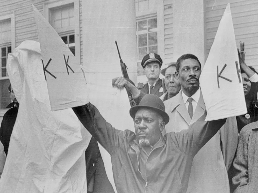 Gun violence hits Black communities hardest. Trump is rolling back prevention efforts 3 Charles Sims, head of the militant African American civil rights organization, the Deacons for Defense and Justice, displays replicas of Ku Klux Klan robes in defiance of the Klan. During the 1960s, racial tensions flared up in Bogalusa.