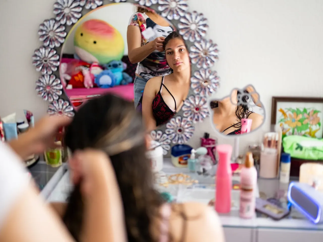 Here, together: Images of community from NPR station photographers 1 Valentina Stone, 14, gets ready for a school dance with the help of her mother, a correctional officer, at their home in the mobile home community next to the now-closed Federal Correctional Institution in Dublin, Calif., on May 30, 2025.