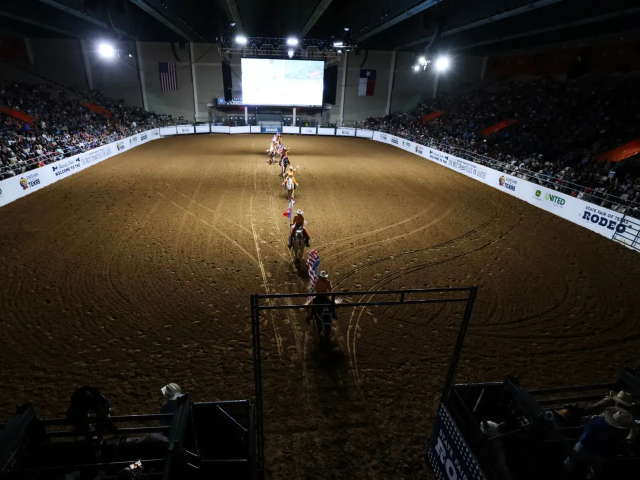 Here, together: Images of community from NPR station photographers 3 Riders make their way across the arena before the Cowboys of Color rodeo Friday, Oct. 13, 2023, at the State Fair of Texas in Dallas.