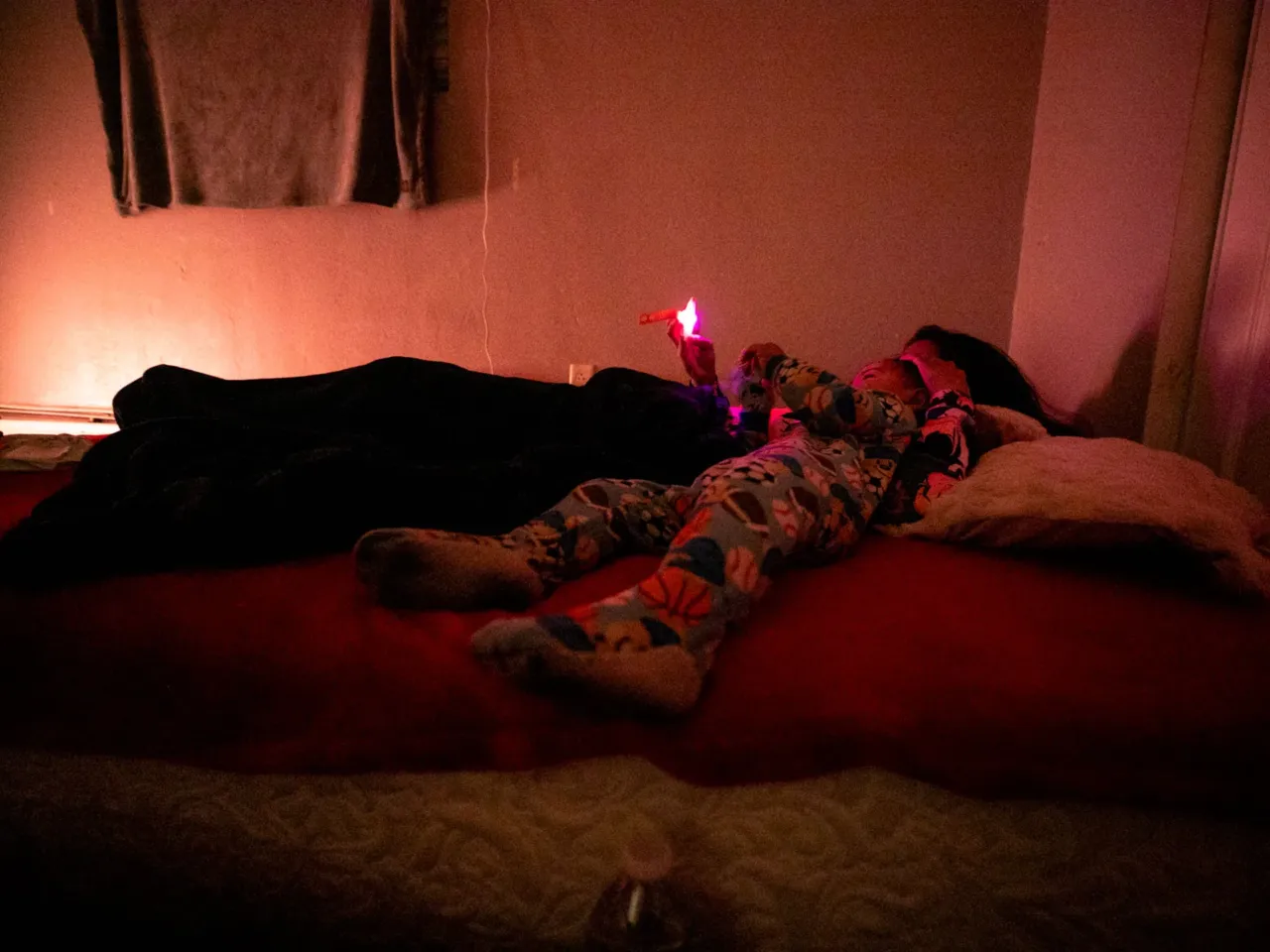 Here, together: Images of community from NPR station photographers 5 Jocelyn, an immigrant from Venezuela, cuddles with her 1-year-old son in the early hours of Feb. 5, 2025, in Aurora, Colo.