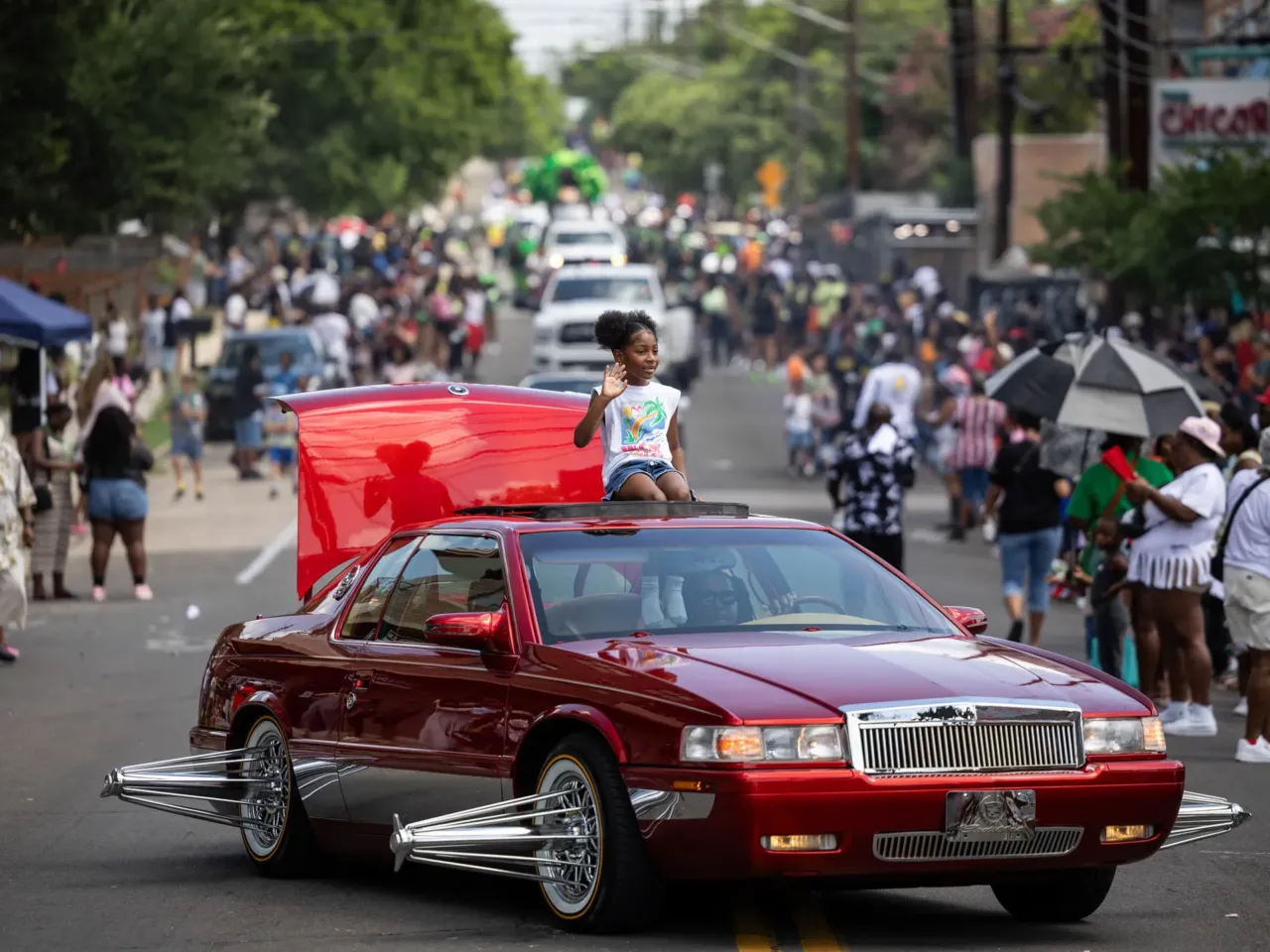Here, together: Images of community from NPR station photographers 7 Juneteenth parade participants wave to attendees along Chicon Street on Thursday, June 19, 2025, in Austin.