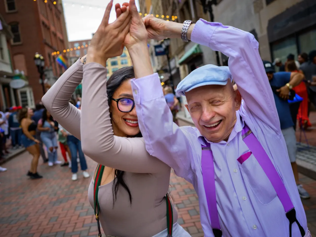 Here, together: Images of community from NPR station photographers 11 Robert McGraph, 79, of Chicopee, Mass., dances with Dawn Orsini during one of this summer's Pratt Street Salsa Socials on June 27, 2025 in Hartford, Conn.
