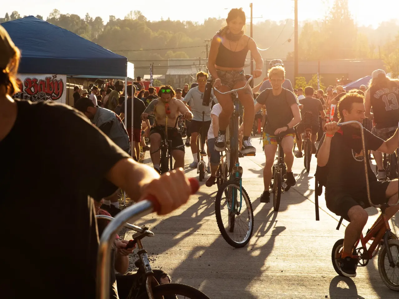 Here, together: Images of community from NPR station photographers 14 Participants ride custom bicycles in the "freak bike petting zoo" during the 28th annual Dead Baby Downhill bike race and party at the Hazard Factory in Seattle, Wash., on Saturday, Aug. 3, 2024.