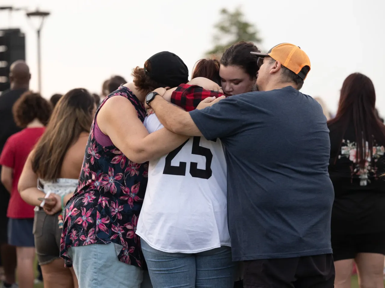 Here, together: Images of community from NPR station photographers 16 Rhonda, Kaylee, Khloe and Nathan Duff embrace one another at a vigil held in Leander, Texas, on Saturday, July 12, 2025. Both Kaylee and Khloe lost friends to the flooding that occurred in their town a week before — one was a local high school band section leader, and another was visiting from out of town.