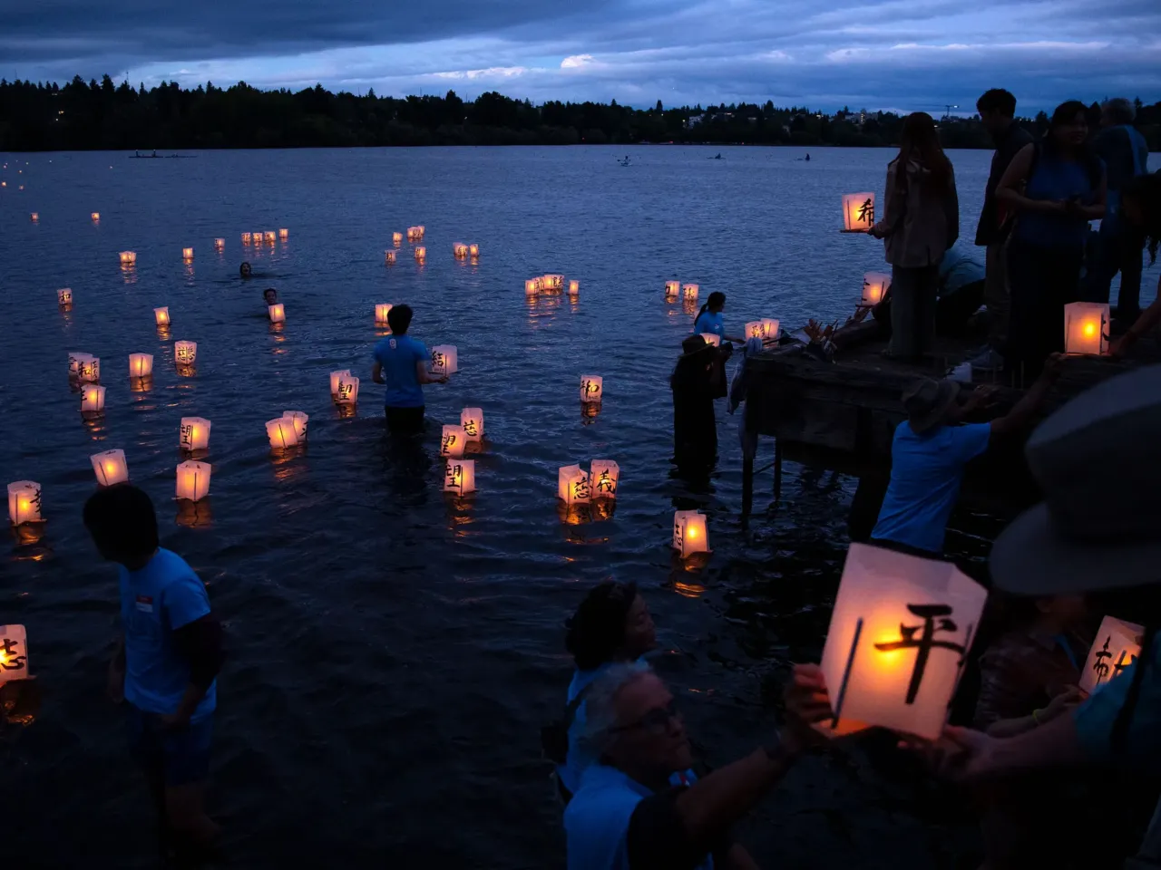 Here, together: Images of community from NPR station photographers 18 Volunteers guide paper lanterns away from the shore as hundreds mark the 80th anniversary of the atomic bombings of Hiroshima and Nagasaki on Wednesday, Aug. 6, 2025, at Green Lake Park in Seattle, Wash. The event, called "From Hiroshima to Hope," has taken place every year, on Aug. 6, on the shores of Seattle's Green Lake since 1984.