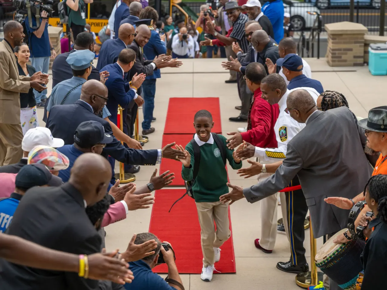 Here, together: Images of community from NPR station photographers 2 Members of Calling All Brothers welcome the students of Dr. Martin Luther King School of Social Justice and Breakthrough Magnet School to their first day of school in Hartford on Aug. 17, 2024.