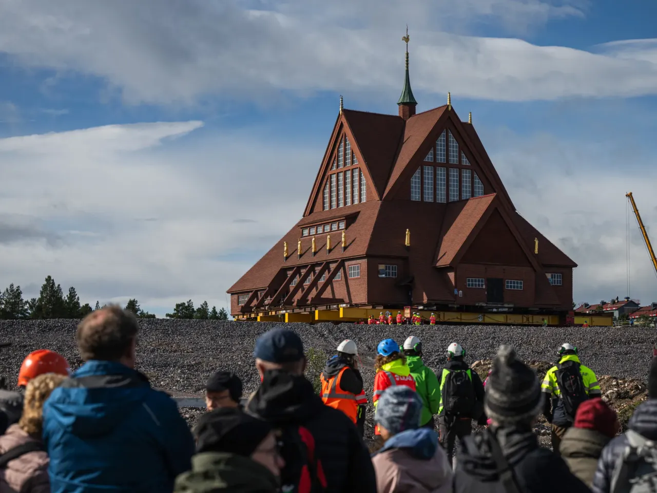 People look at wooden Kiruna Church at its final location after a two-day move from the old town to the new city center, in Kiruna, northern Sweden, on August 20.