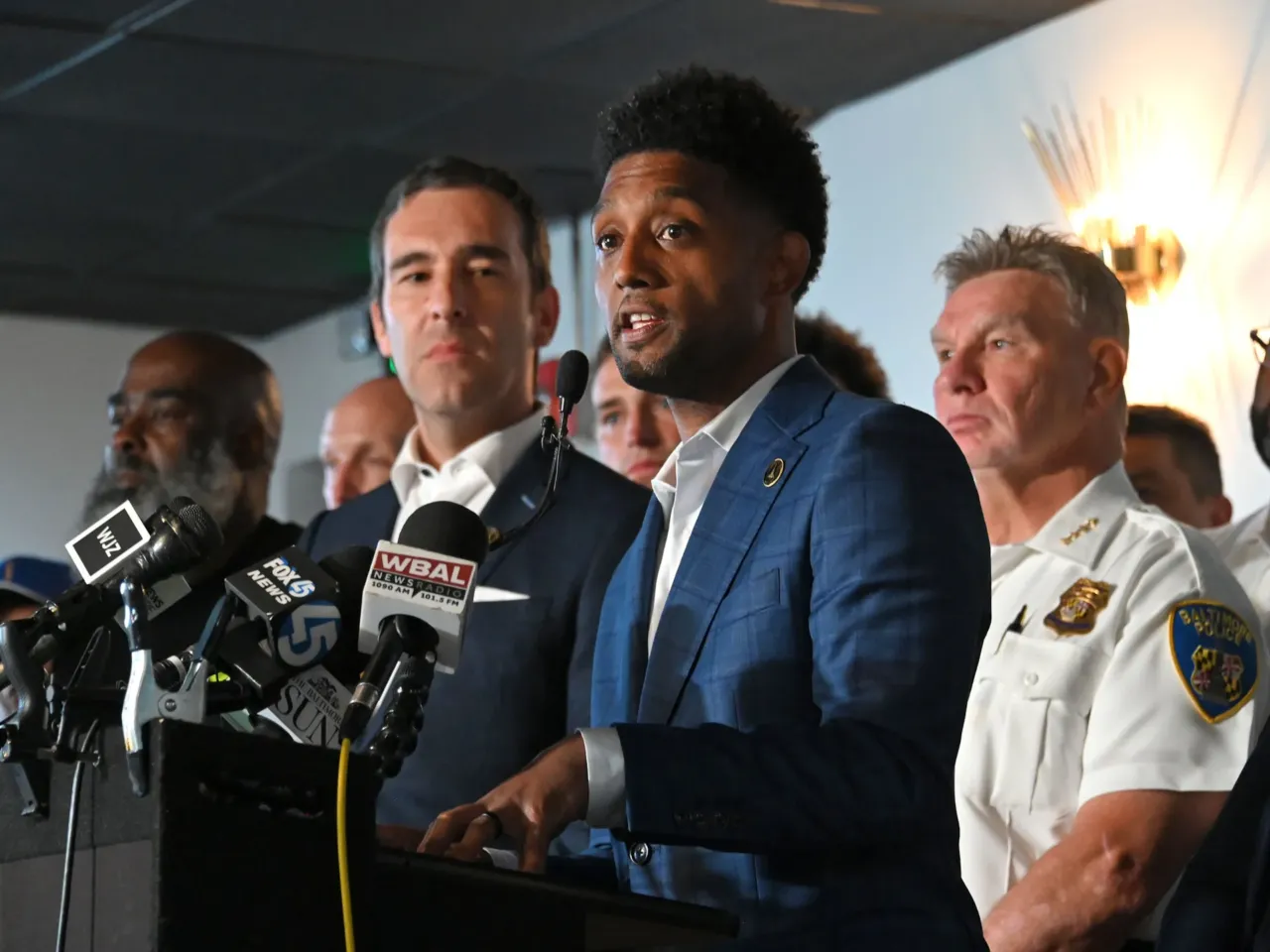 Baltimore Mayor Brandon Scott, City Council President Zeke Cohen, Police Commissioner Richard Worley and other officials announce the expansion of the city's Group Violence Reduction Strategy in Cherry Hill on July 23, 2025, in Baltimore.