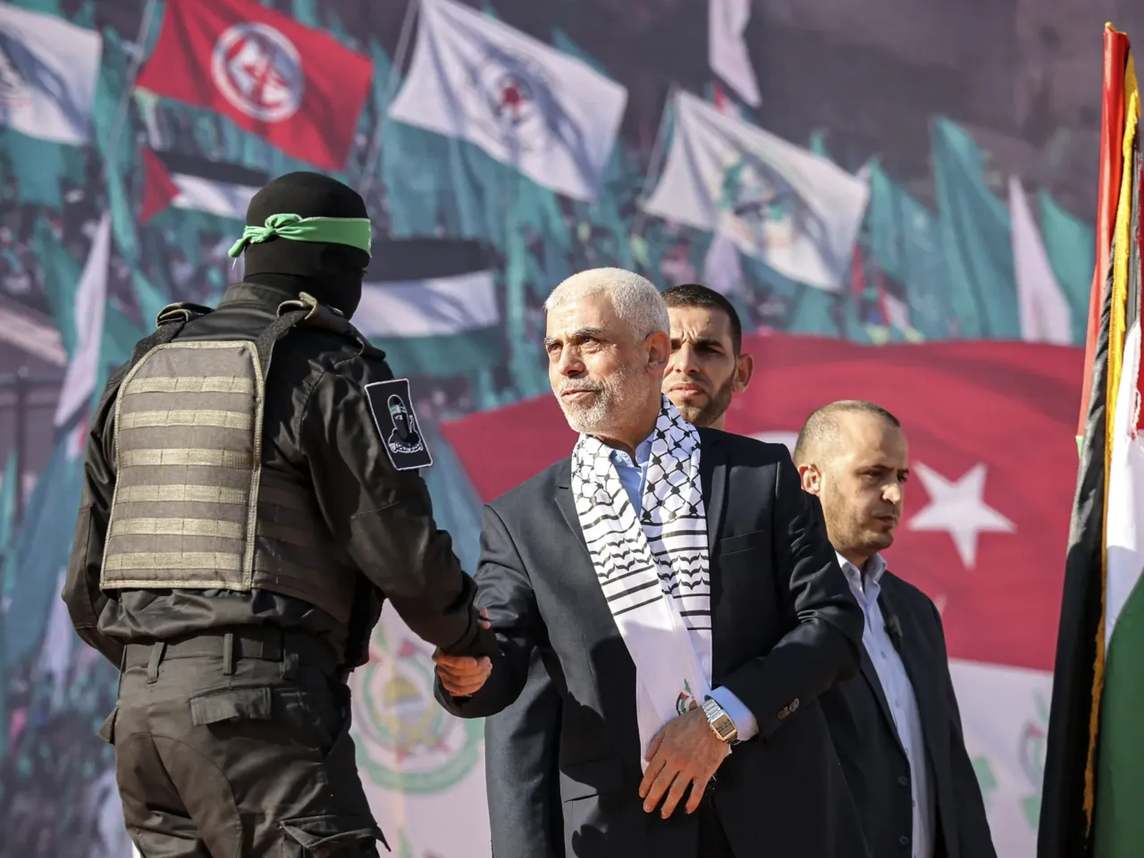 Hamas has one top strategy: End the war and survive 1 Yahya Sinwar (center), Hamas' Gaza Strip chief at the time, shakes hands with a masked fighter of the group's Qassam Brigades during an anniversary rally, in Gaza City, on Dec. 14, 2022. Israel believes Sinwar was a mastermind of the deadly Oct. 7, 2023, attack in the country. The Israeli military said it killed him in an operation in southern Gaza in October 2024.