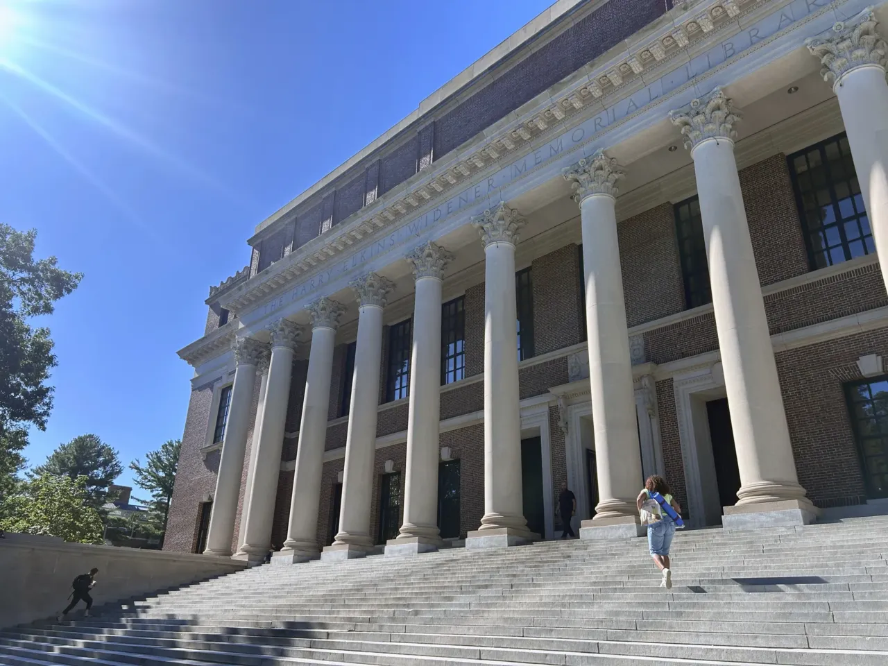 Students walk up the steps of the Harry Elkins Widener Memorial Library on the campus of Harvard University.