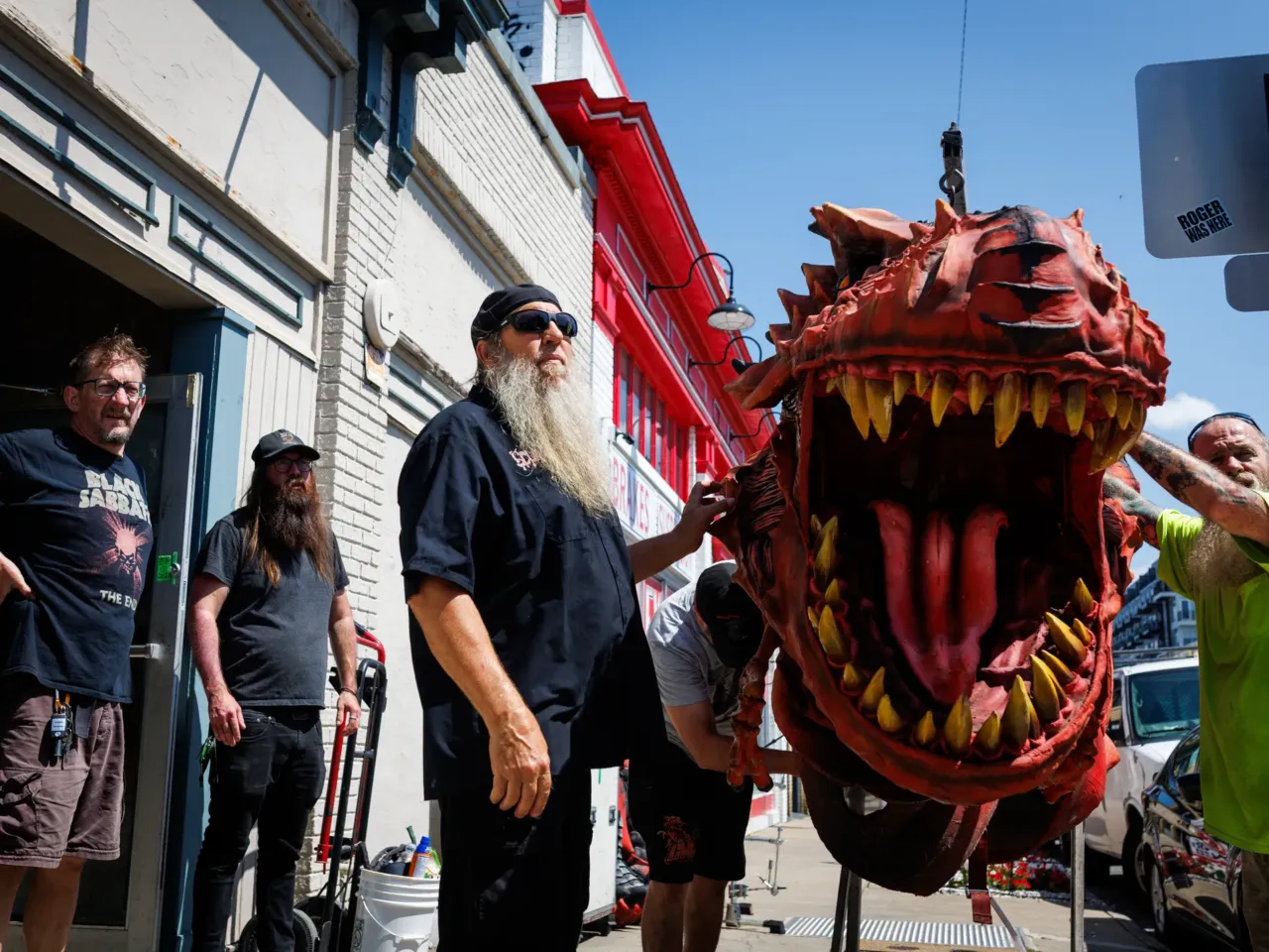Michael Derks (left), Balsac the Jaws of Death's human thrall, loads Gor-Gor into the truck along crew member Jesse Phillips; Andrew Reilly, a friend of GWAR; art director Matt Maguire; and friend of GWAR Ronnie Cook as they prepare for the set at Allianz Amphitheater on Thursday, July 24, 2025 in Richmond, Virginia.
