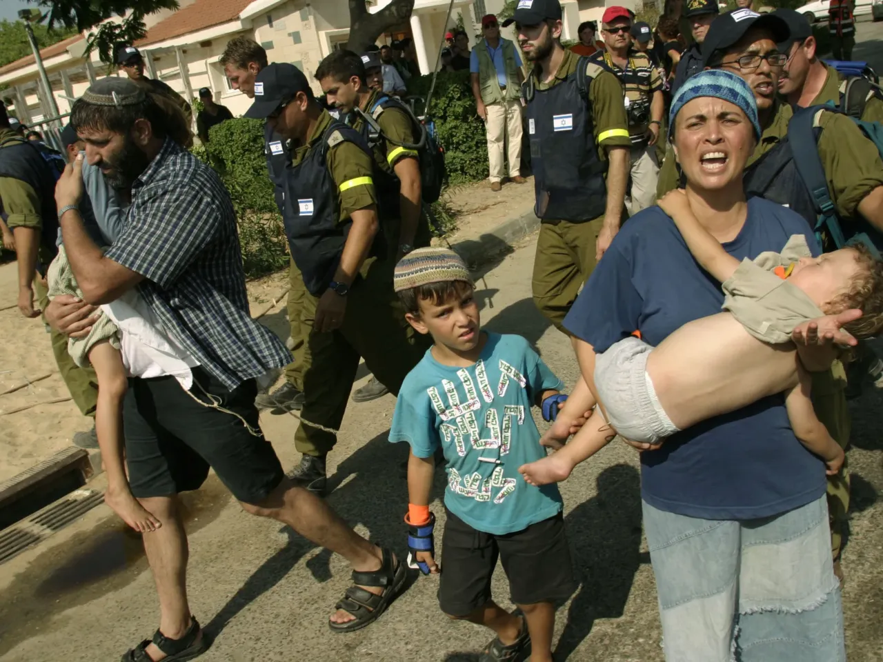 20 years later, Israelis ask if the Gaza exit backfired — and if it's time to go back 1 Settlers carry their children upon being evacuated from their homes in the Gaza Strip settlement of Neve Dekalim, Aug. 17, 2005. Thousands of Israeli security forces poured into Jewish settlements in Gaza to begin the forcible removal of settler protesters who ignored orders to leave the area ahead of the withdrawal deadline.