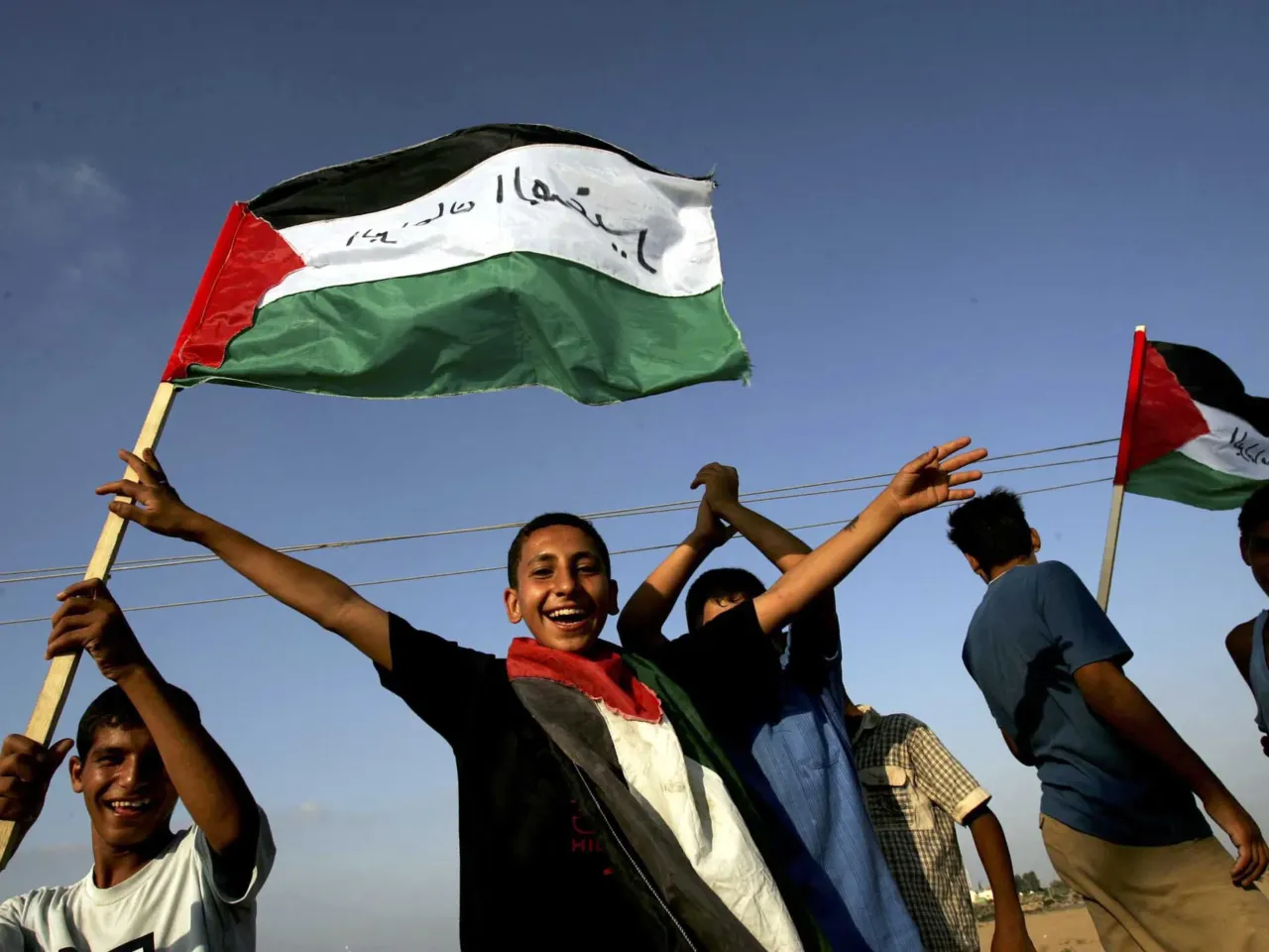 20 years later, Israelis ask if the Gaza exit backfired — and if it's time to go back 2 Palestinian boys wave Palestinian flags and cheer near the settlement of Morag, at their post in Rafah refugee camp in the southern Gaza Strip, Aug. 17, 2005. Israeli security forces began to forcibly evacuate Jewish settlers who ignored official orders to leave the area ahead of the withdrawal deadline.