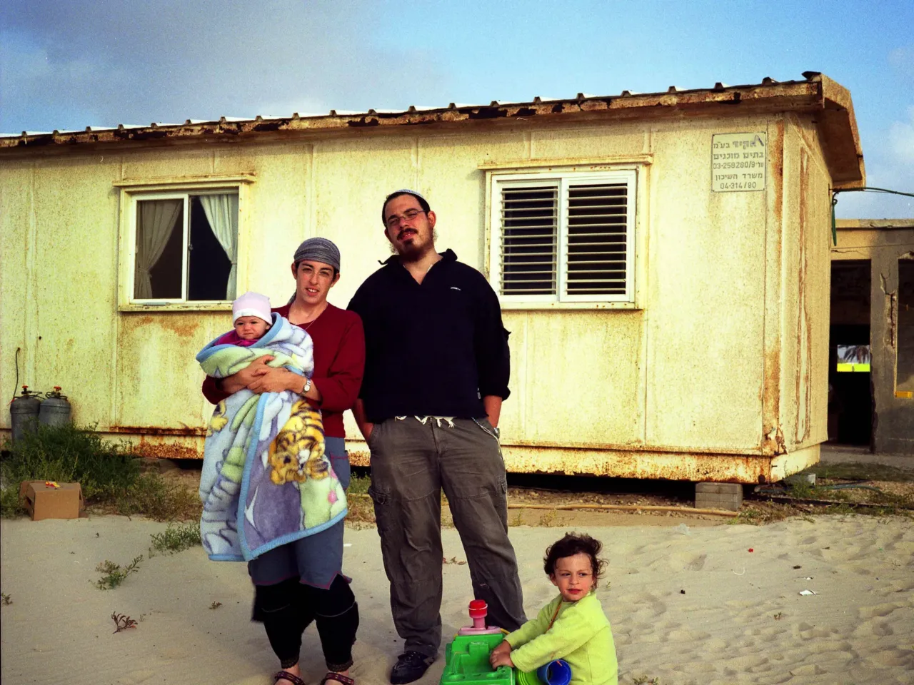 20 years later, Israelis ask if the Gaza exit backfired — and if it's time to go back 4 The Vitcon family, the mother Rachel holding baby girl Sharodechya, father Avi-Nadav and Mevaser, stands for a portrait in front of their house that they lived in for four years, in the settlement of Shirat Hyam in Gush Katif, Gaza Strip, on May 11, 2005.
