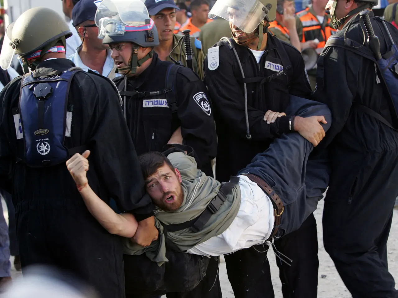 20 years later, Israelis ask if the Gaza exit backfired — and if it's time to go back 5 A hard-line Israeli settler is being carried away by Israeli security forces who launched an assault on anti-disengagement activists entrenched on the roof of a synagogue in the Gaza Strip settlement of Kfar Darom, Aug. 18, 2005.